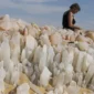 Travelers exploring the sparkling quartz formations of Crystal Mountain in Egypt’s desert near Bahariya Oasis.