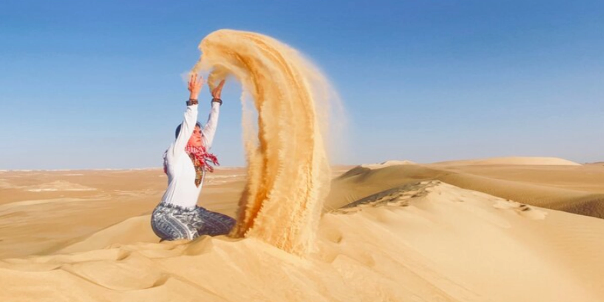 Backpack with essential gear for exploring Siwa Oasis, including hiking shoes, water bottle, camera, and sunscreen, ready for a Heart Egypt Tours adventure.