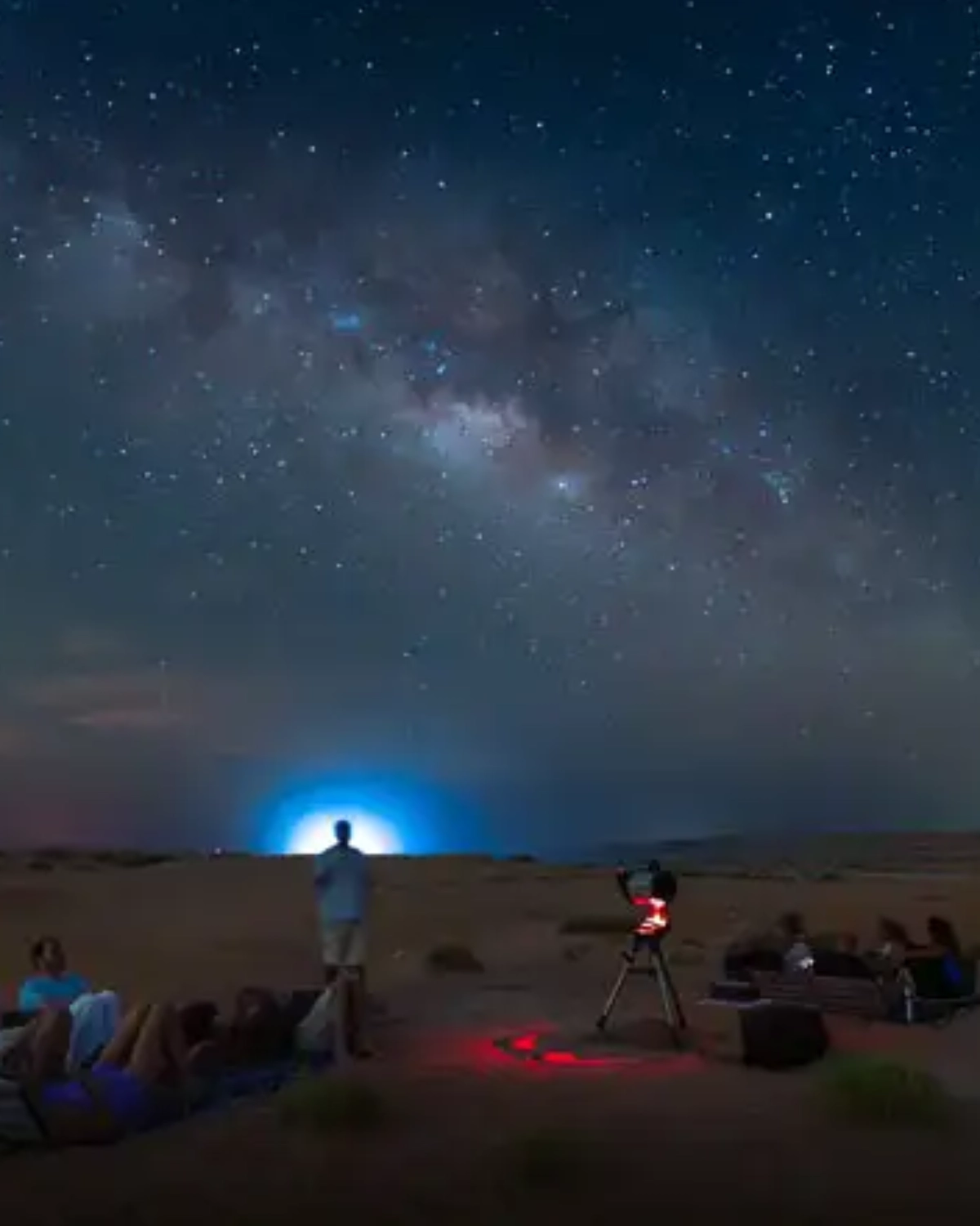 Desert campsite with tents and campfire under a starry sky in the White Desert, prepared for a Heart Egypt Tours guided night.