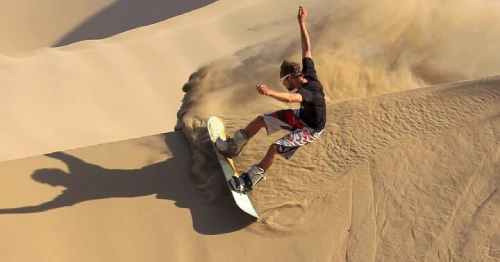 Travelers sandboarding and riding dune buggies in Egypt’s White and Black Deserts.