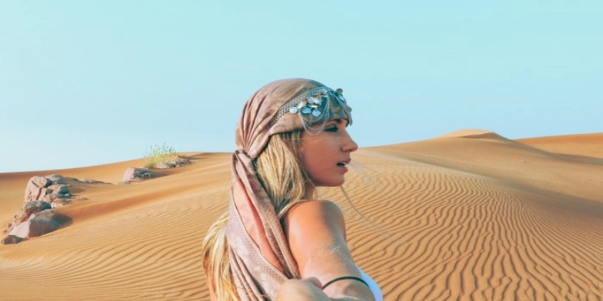 Traveler’s backpack with hiking gear, water bottle, sunscreen, and camera, ready for exploration of Fayoum Oasis and desert with Heart Egypt Tours.